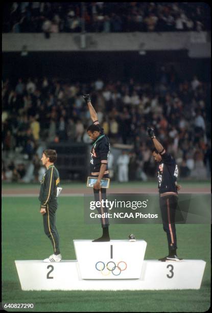 Tommie Smith Peter Norman of Australia and John Carlos of the US raise their fists in the "Black Power Salute" during the playing of the national...