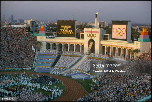Rafer Johnson lights the Olympic flame at the opening ceremony during the Olympic games in Los Angeles, CA. He is shown at the top of the steps,...
