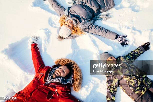 winter breaks - snow angel stock pictures, royalty-free photos & images