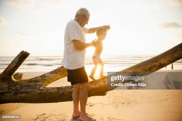 opa en kleinzoon - seniors having fun with grandson stockfoto's en -beelden