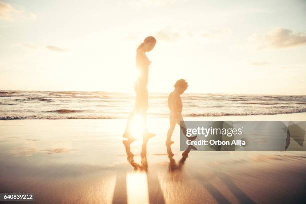 mother walking with son - mexican and white baby stock pictures, royalty-free photos & images