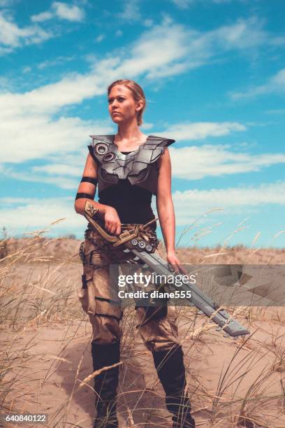 futuristic female warrior standing in the desert - hot big women stock pictures, royalty-free photos & images