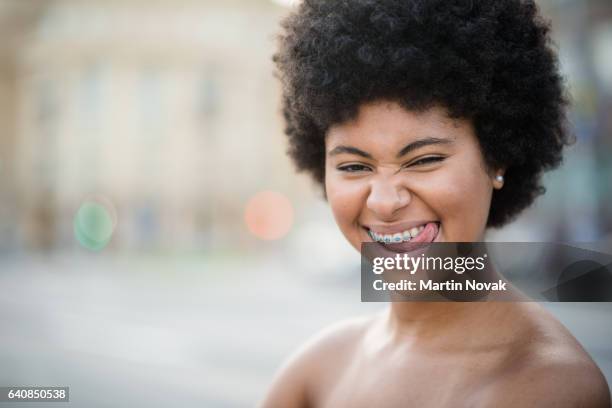 cheeky teenager sticking her tongue out - female laughing face stock pictures, royalty-free photos & images