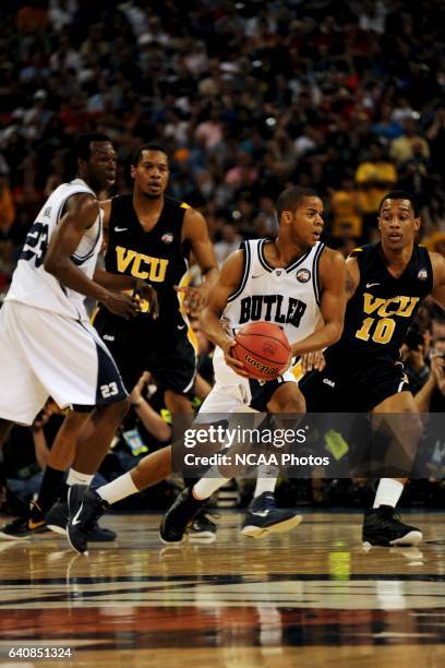 Ronald Nored of Butler University drives down court against Darius Theus of Virginia Commonwealth University during the semifinal game of the 2011...