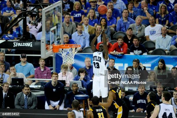 Khyle Marshall of Butler University shoots a three pointer over Bradford Burgess of Virginia Commonwealth University during the semifinal game of the...