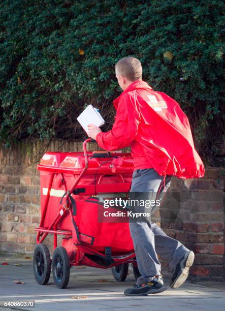 uk, great britain, england, view of postman delivering mail - postal worker stock pictures, royalty-free photos & images