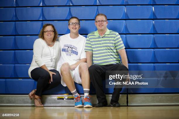 Josh Speidel poses for a portrait with his parents Dave and Lisa in his high school gym in Columbus, Ind.. AJ Mast/ NCAA Photos via Getty Images