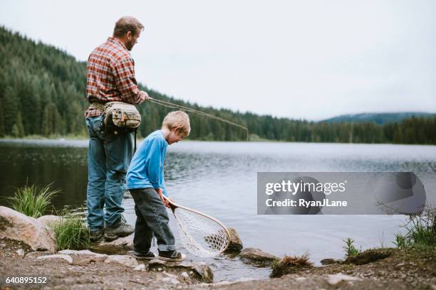 father fly fishing with son - trout fishing stock pictures, royalty-free photos & images