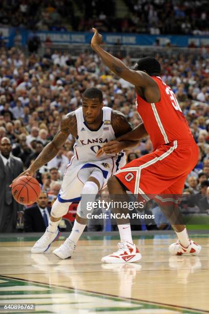 Forward Thomas Robinson from the University of Kansas drives to the basket past Evan Ravenel from Ohio State University during the Semifinal Game of...