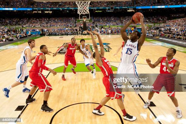 Guard Elijah Johnson from the University of Kansas puts up a shot in front of guard Lenzelle Smith Jr. From Ohio State University during the...