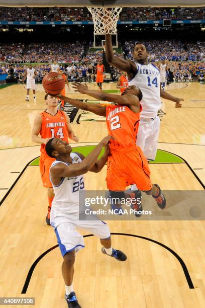 Guard Russ Smith from the University of Louisville attempts a shot between the defense of teammates guard Marquis Teague and forward Michael...