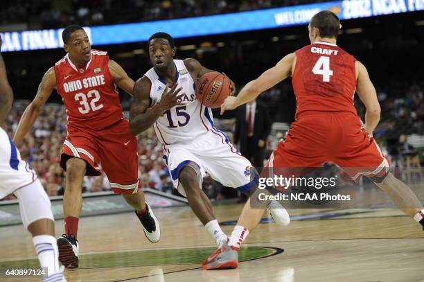 Guard Elijah Johnson from the University of Kansas drives to the basket past Lenzelle Smith Jr. And Aaron Craft from Ohio State University during the...