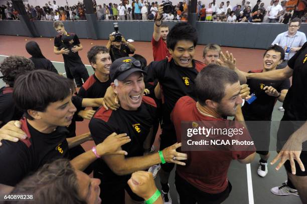 University of Southern California teammates celebrates with Coach Peter Smith after winning the Division I Men?s Tennis Championship held at the Dan...