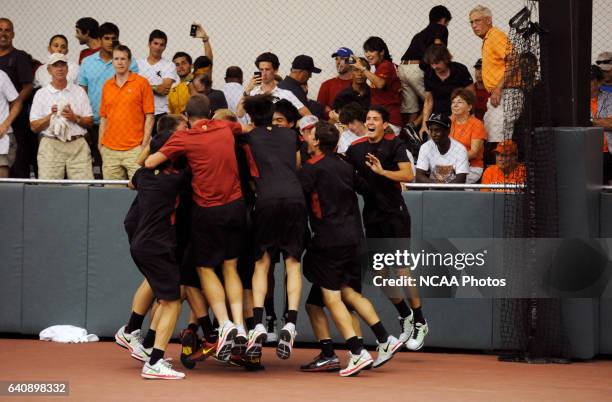 Members of the University of Southern California tennis team celebrate after winning the Division I Men?s Tennis Championship held at the Dan Magill...