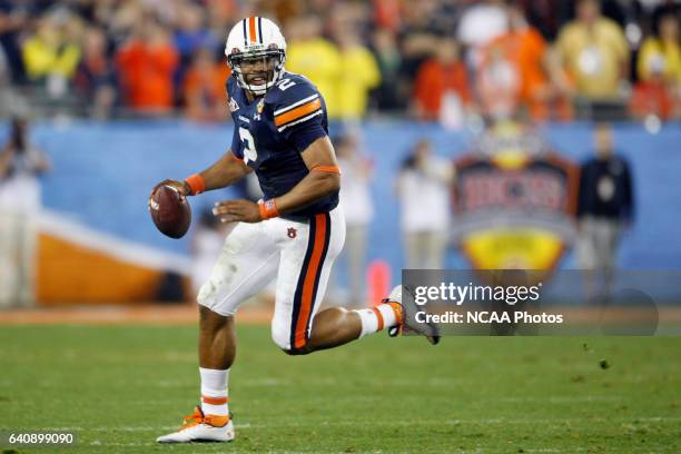 Quarterback Cam Newton of Auburn University rushes the ball against the University of Oregon during the Tostitos BCS National Championship held at...