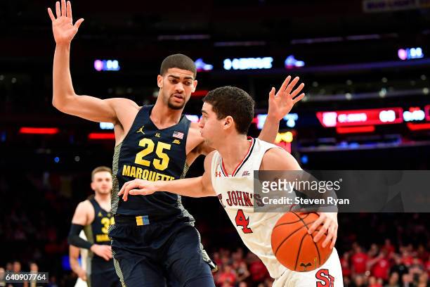 Federico Mussini of the St. John's Red Storm is defended by Haanif Cheatham of the Marquette Golden Eagles at Madison Square Garden on February 1,...