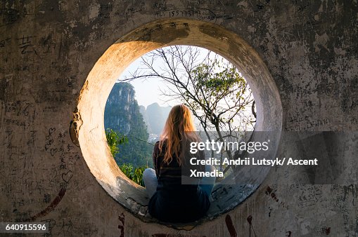 Young woman enjoys view over Yangshuo, karst mountains Young woman enjoys view over Yangshuo, karst mountains