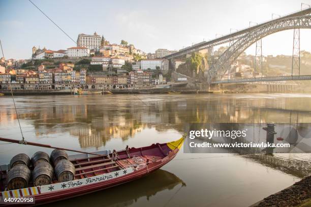 historical port wine ship at river douro with ponte luis i in oporto, portugal - porto portugal stock-fotos und bilder