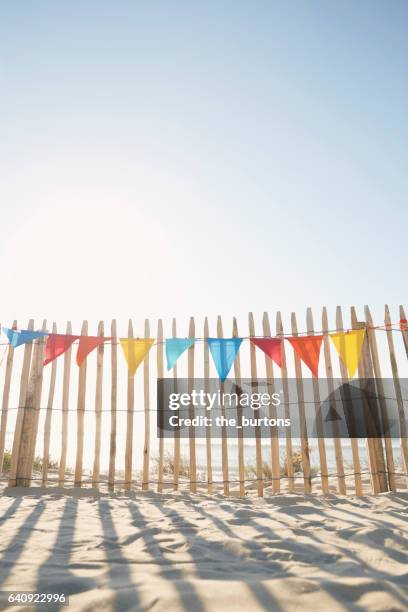 colourful bunting flags for party decorations at beach - festoon lights stock pictures, royalty-free photos & images