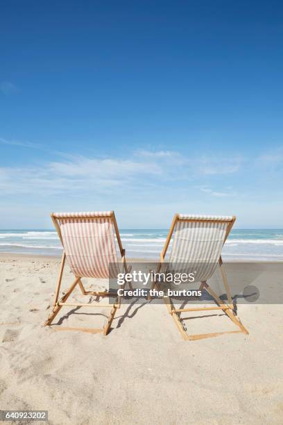 two deck chairs at beach - beach deck chairs stock-fotos und bilder