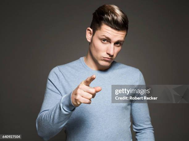 young man with challenging gesture - guy pointing stock pictures, royalty-free photos & images