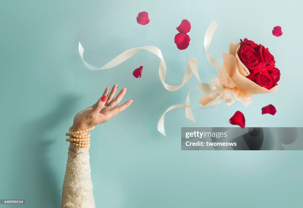 Bride throwing bouquet in mid air.