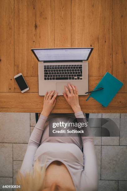 pregnant woman working on laptop - aerial view desk stock pictures, royalty-free photos & images