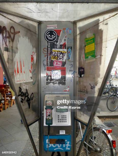 europe, germany, berlin, view of graffiti covered payphone telephone booth - telefonzelle stock-fotos und bilder