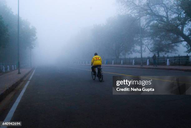 cycling - delhi fog stock pictures, royalty-free photos & images