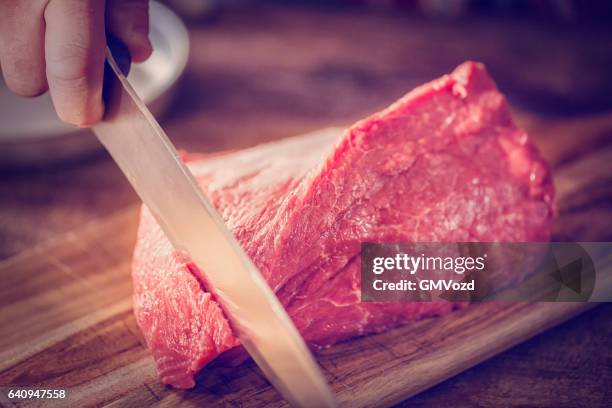 cutting fresh meat - butchers shop stock pictures, royalty-free photos & images