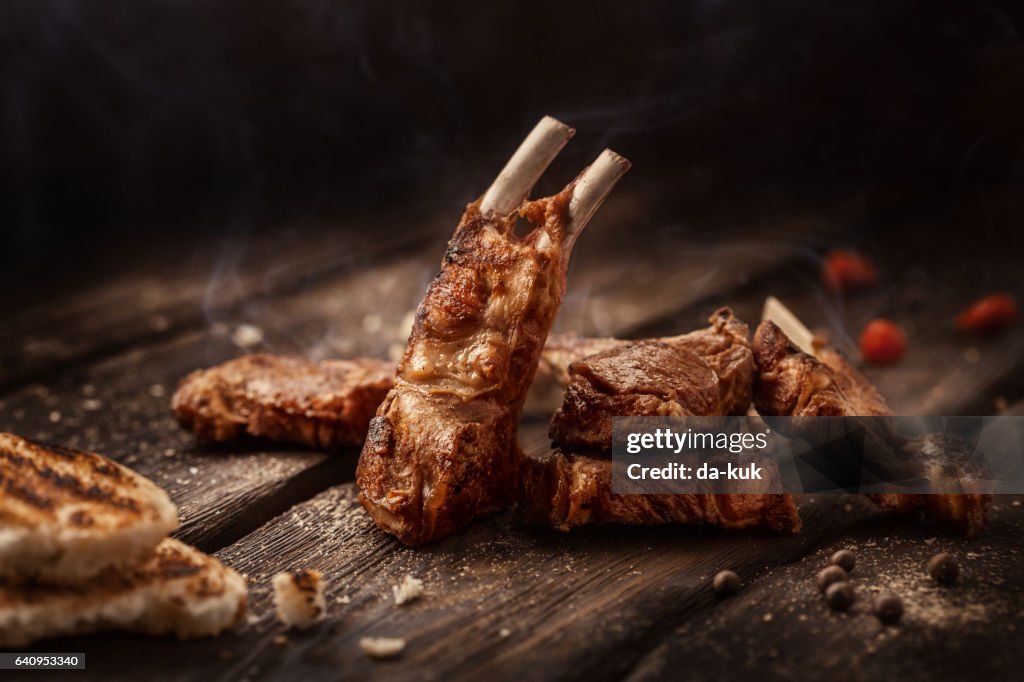 Grilled lamb chops on wooden table