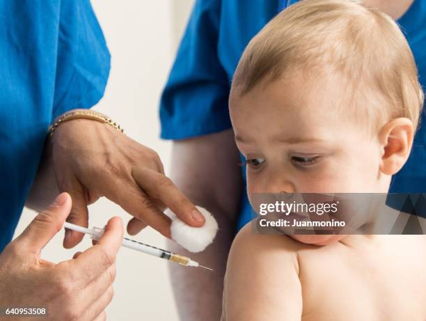 baby boy being vaccinated - baby vaccination stock pictures, royalty-free photos & images