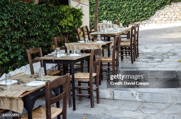empty tables - plaka greek cafe stock pictures, royalty-free photos & images