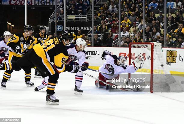 Phil Kessel of the Pittsburgh Penguins puts the game winning goal past Sergei Bobrovsky of the Columbus Blue Jackets at PPG PAINTS Arena on February...