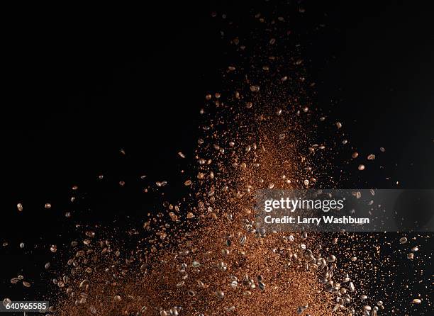 ground coffee beans in mid-air against black background - ground coffee stock pictures, royalty-free photos & images