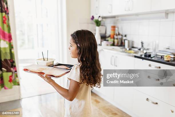 girl carrying food in tray at day care center - platter side bildbanksfoton och bilder