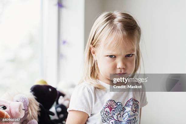 portrait of angry little girl at classroom - displeased stockfoto's en -beelden