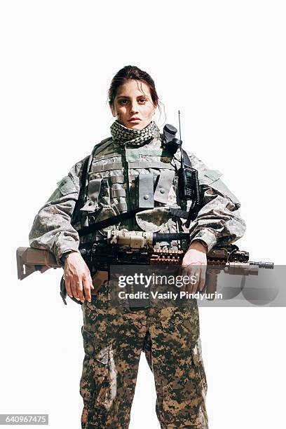 portrait of female soldier standing with rifle against white background - military courage stock pictures, royalty-free photos & images