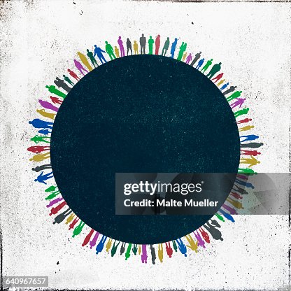 Multi colored people standing side by side around circle Multi colored people standing side by side around circle