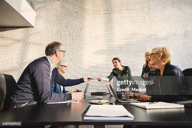 multi-ethnic business people discussing at table in creative office - planned giving stock pictures, royalty-free photos & images