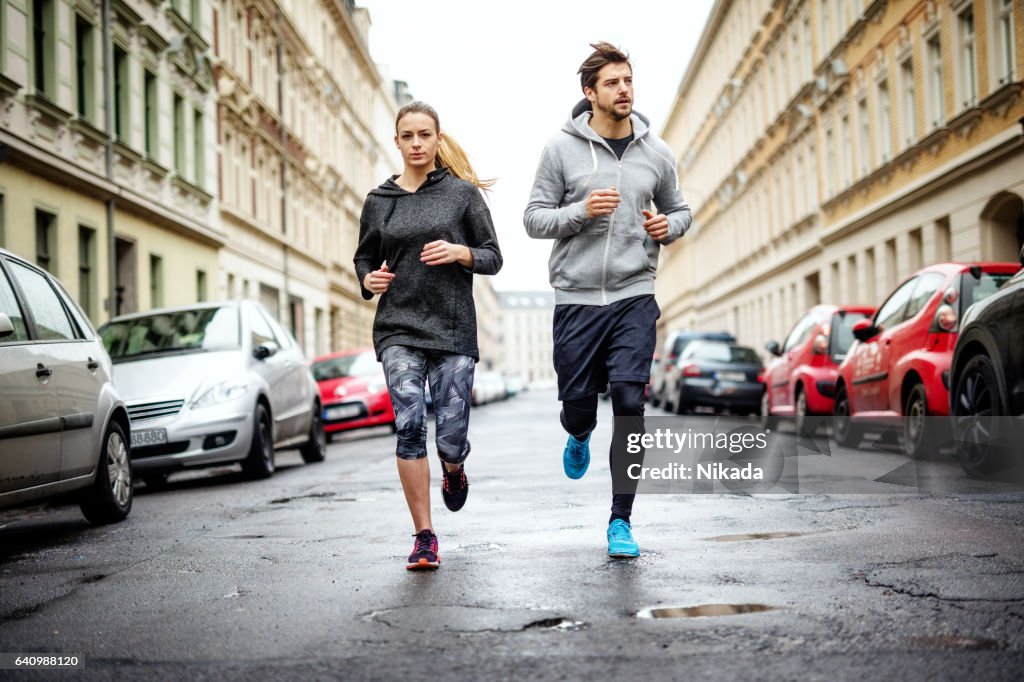 Couple running together in the city