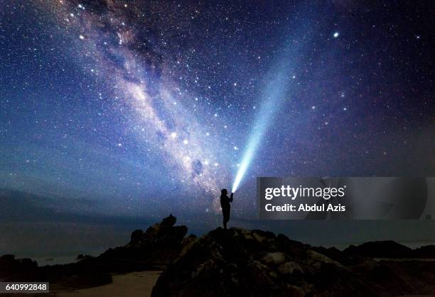 selfie with milkyway at sawarna beach bayah indonesia - torcia elettrica foto e immagini stock