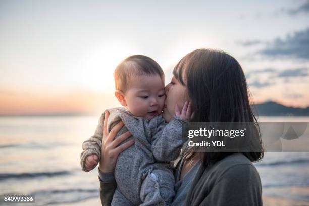 a baby and mother. - japanese baby photos et images de collection