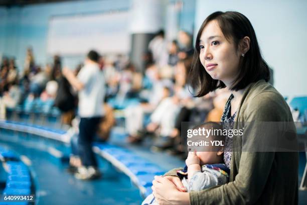 a baby and mother at stadium. - スポーツ施設 ストックフォトと画像