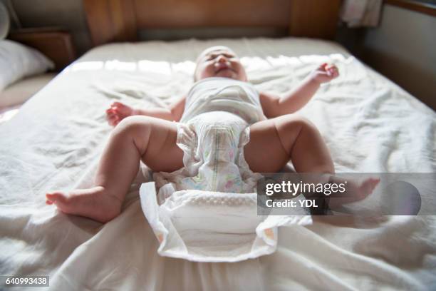 a crying baby complains changing diapers. - changing diaper ストックフォトと画像
