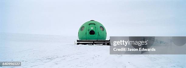a bright green apple hut also called an igloo satellite cabin, are light-weight field shelters hemispherical in shape. - igloo isolated stock pictures, royalty-free photos & images