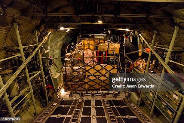 the cargo hold of a us air force hercules flying to antarctica at night. - vrachtruimte stockfoto's en -beelden