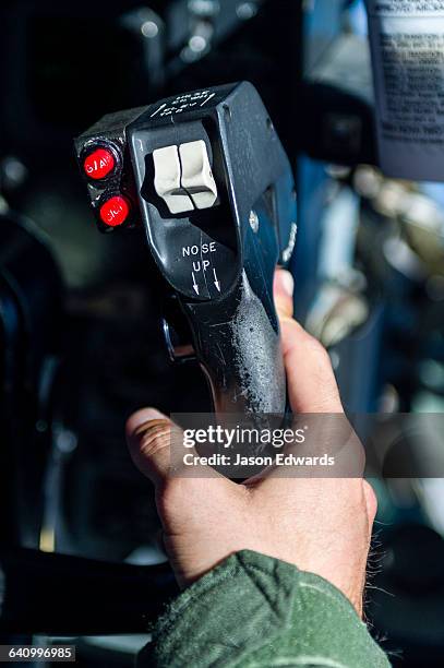 a us air force co-pilot flying a hercules to antarctica using the control joystick. - joystick stock-fotos und bilder