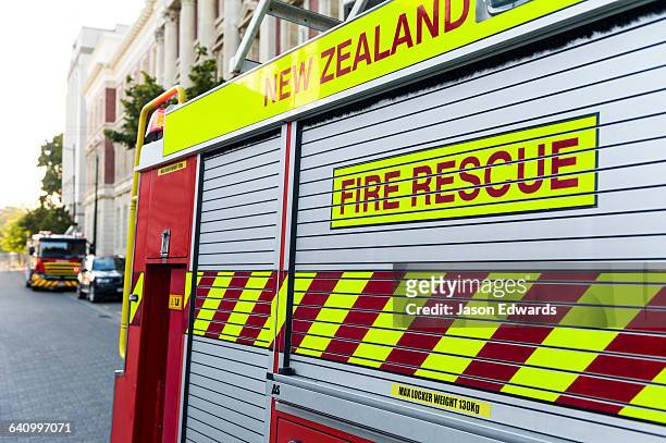 a fire engine outside of a hotel after a false alarm. - firetruck stock pictures, royalty-free photos & images
