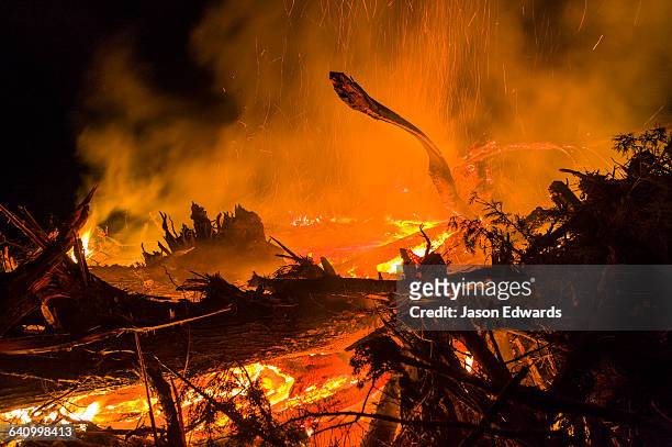 flames and sparks fly into the air as a farmer burns surplus timber in a bonfire on his farm during winter. - bushfires burn across victoria stock pictures, royalty-free photos & images
